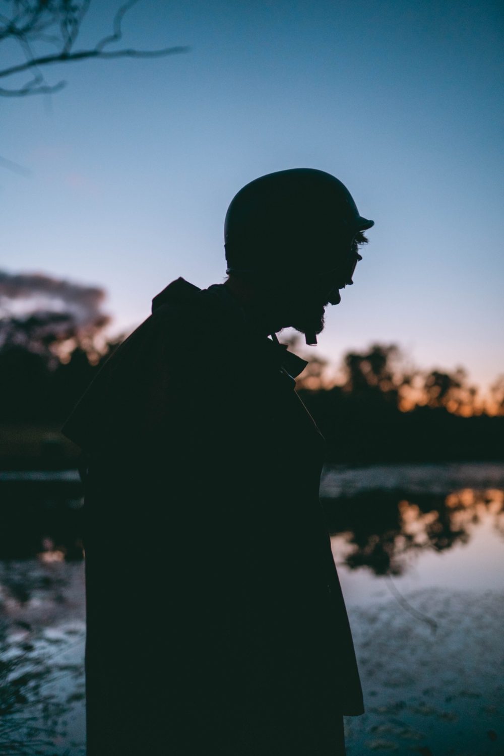 Pete's helmet and long weathered coat silhouetted against the evening sky.